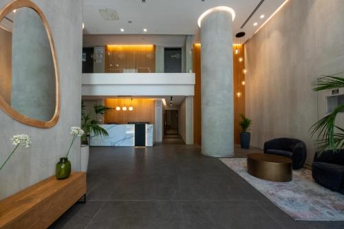 an office lobby with a reception desk and a mirror at O&O Group - 3BR Skyline Retreat on the 24th Floor in Bat Yam