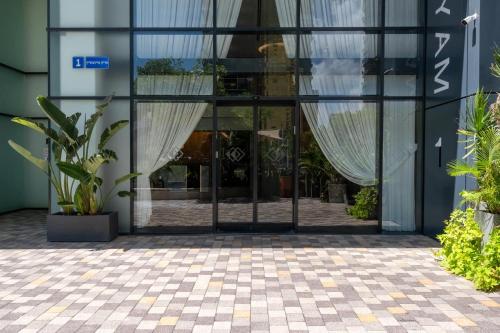 an entrance to a building with a glass door at O&O Group - 3BR Skyline Retreat on the 24th Floor in Bat Yam