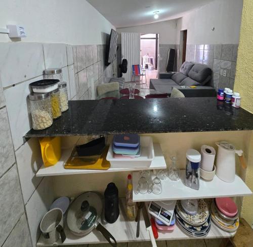 a kitchen and living room with a counter top at Aluguel de quarto por diaria proximo ao aeroporto e rodoviaria in São Luís