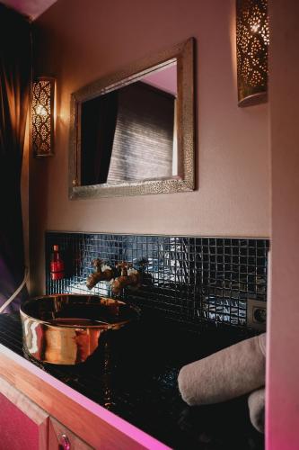 a bathroom with a sink and a mirror at Ô Secret in Liège