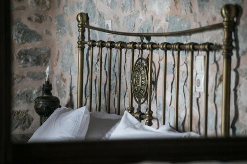 a close up of a metal bed frame in a bedroom at Ktima Karageorgou in Areopolis