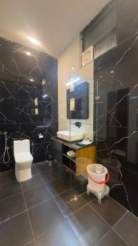 a bathroom with a toilet and a sink and a mirror at Ekanta by nature in Pushkar