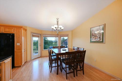 a dining room with a table and chairs at Fort Wine Burrow, Entire Private Estate Home in Maple Ridge District Municipality