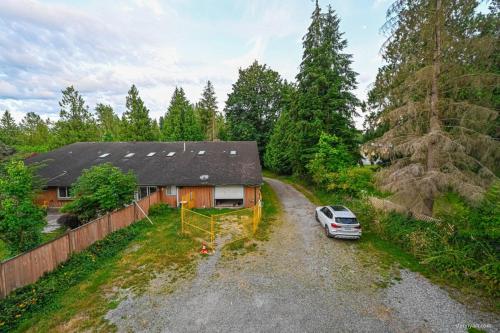 a car parked in the driveway of a house at Fort Wine Burrow, Entire Private Estate Home in Maple Ridge District Municipality