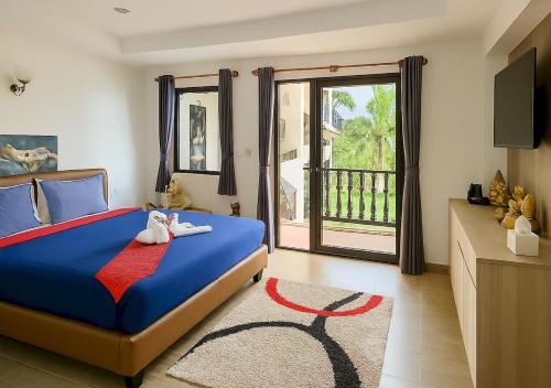 a bedroom with a blue bed and a balcony at Beverly Hills Villa Patong in Patong Beach
