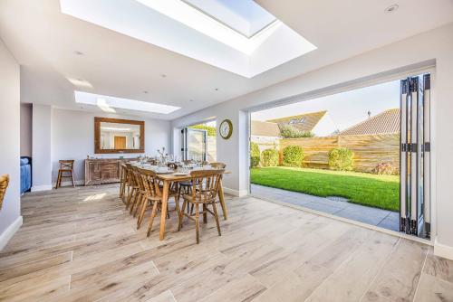 a kitchen and dining room with a table and chairs at Windrocks - Bracklesham Bay in Chichester