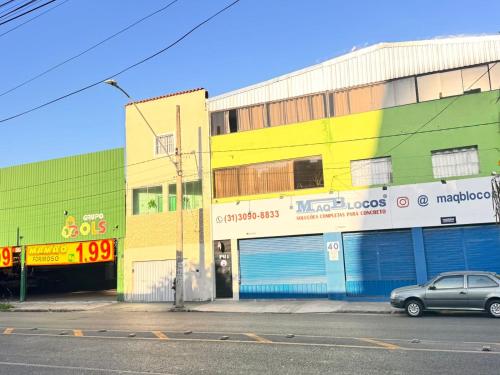a building with a car parked in front of it at Uai Sô Hostel in Belo Horizonte