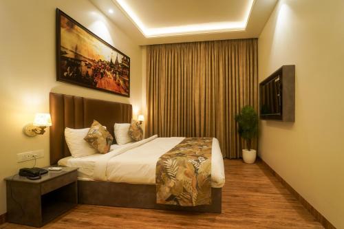 a hotel room with a bed and a large window at Sugar Stars Inn in Varanasi