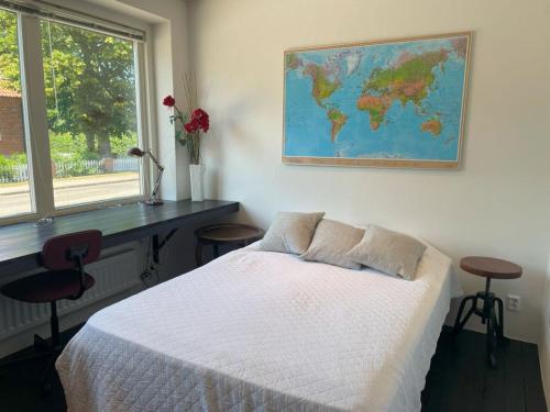 a bedroom with a bed and a map on the wall at Udda boende med wow-känsla in Löderup