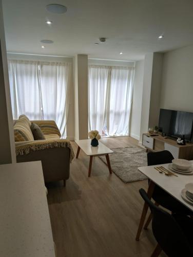 a living room with a couch and a table at Leeds Arena Luxury Appt in Leeds