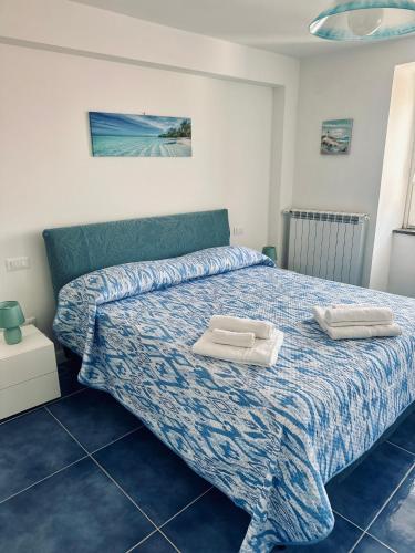 a bedroom with a bed with two towels on it at La Casa di Nonno Ciccio in Vico Equense