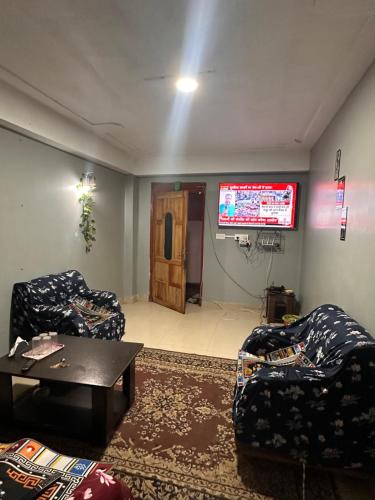 a living room with two chairs and a tv at Karma homestay in Ravangla
