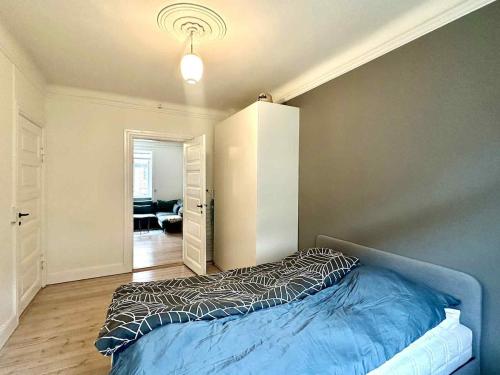 a bedroom with a bed in a room at Spacious Nordic Design Vesterbro Home I 3 min to Metro in Copenhagen