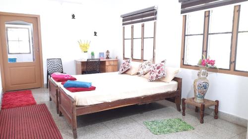 a room with a bed with pillows on it at David Homes in Cochin