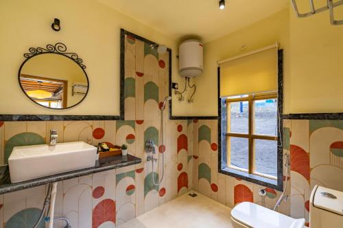 a bathroom with a sink and a mirror at House on the Clouds, Spiti in Domli