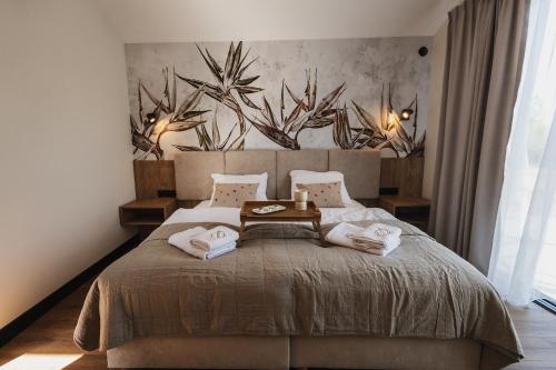 a bedroom with a large bed with two pillows at Apartamenty Na Stawach 24 in Stary Sącz