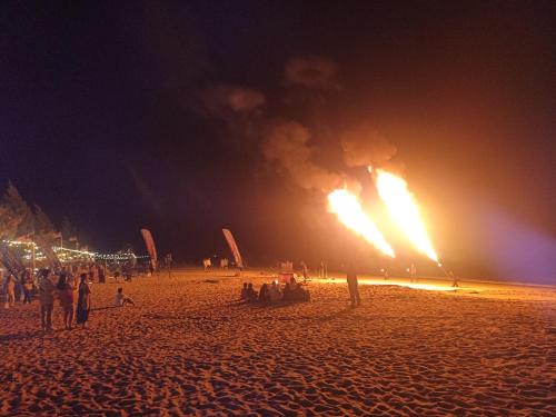 a group of people on a beach at night at Sri sayang pearl view in Batu Ferringhi