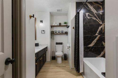 a bathroom with a toilet and a sink and a tub at Bourbon Trail-Speakeasy&Golf&Spa&Dog Friendly in Frankfort