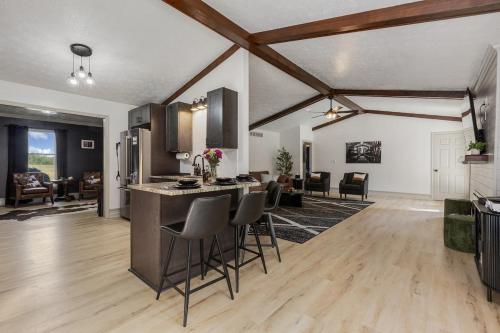a kitchen and living room with a counter and chairs at Bourbon Trail-Speakeasy&Golf&Spa&Dog Friendly in Frankfort