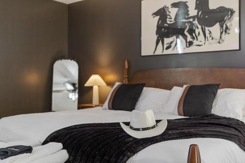 a bedroom with a bed with a hat on it at Bourbon Trail-Speakeasy&Golf&Spa&Dog Friendly in Frankfort