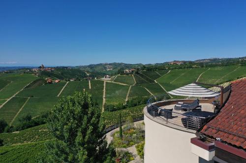 an aerial view of a vineyard with a house and a building at Il Boscareto Resort & Spa in Serralunga d'Alba