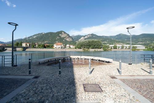 a group of benches next to a body of water at Front Lake Como - 3 Bedrms with AC, Free Parking and Wifi in Olginate