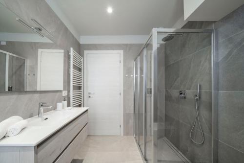 a bathroom with a shower and a sink at Front Lake Como - 3 Bedrms with AC, Free Parking and Wifi in Olginate