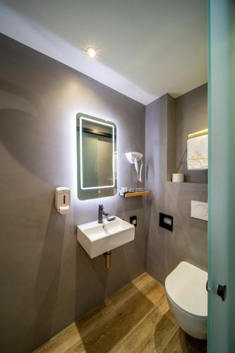 a bathroom with a sink and a toilet at Jupiter Hotel in Amsterdam