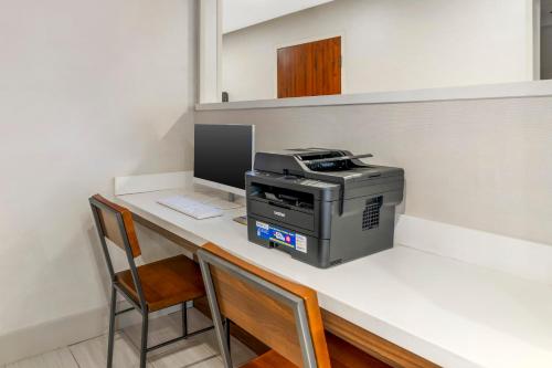 a desk with a printer and a computer on it at Keene Elm City Hotel, an Ascend Collection Hotel in Keene