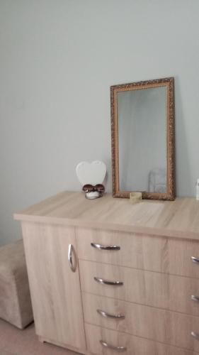 a dresser with a mirror on top of it at Arti House at Selvia in Tirana