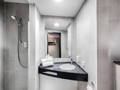 a bathroom with a sink and a shower at B&B HOTEL St-Pölten in Sankt Pölten
