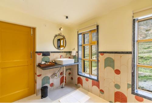 a bathroom with a sink and a mirror at House on the Clouds, Spiti in Domli