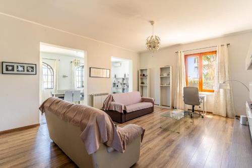 a living room with a couch and a chair at Casa Matilde Vista Mare con Piscina by Wonderful Italy in Carrozziere – Fonte Ciane