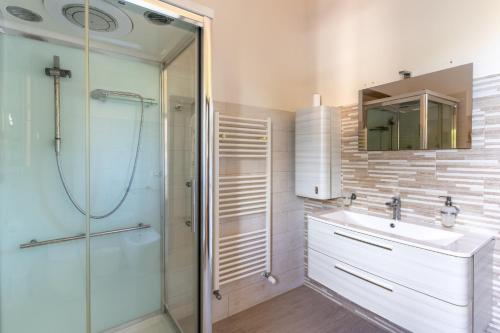 a bathroom with a shower and a sink and a mirror at Casa Matilde Vista Mare con Piscina by Wonderful Italy in Carrozziere – Fonte Ciane