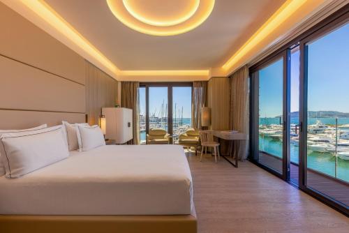 a hotel room with a bed and a large window at Porto Lotti Suite Hotel in La Spezia