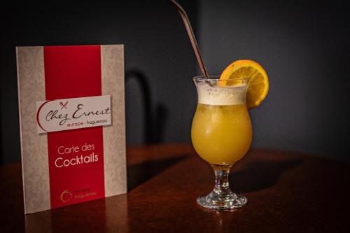 a glass of orange juice next to a bag of coke at Europe Haguenau – Hotel & Spa in Haguenau