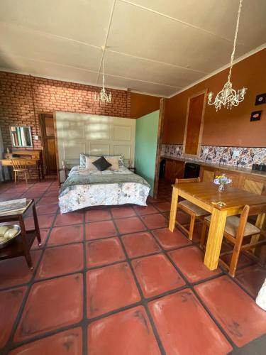 a bedroom with a bed and a table at Bokmakierie Studio in Montagu