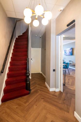 a red staircase in a house with a red carpet at Jupiter Hotel in Amsterdam