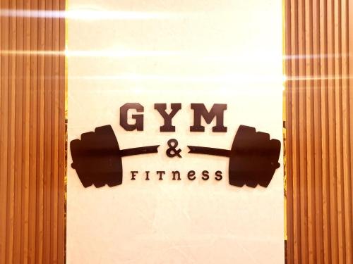 a sign that says gym and fitness on a door at جزيرة اللؤلؤ للشقق الفندقية PEARL ISLAND HoTEL APARTMENT in Al Buraymī