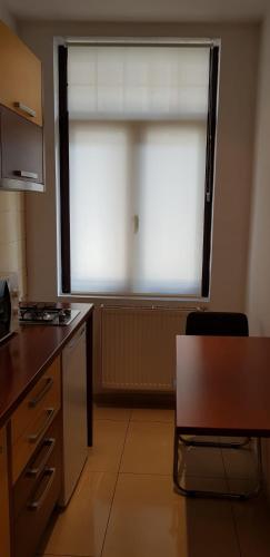 a kitchen with a large window in a room at GrandVille Apartments in Bucharest