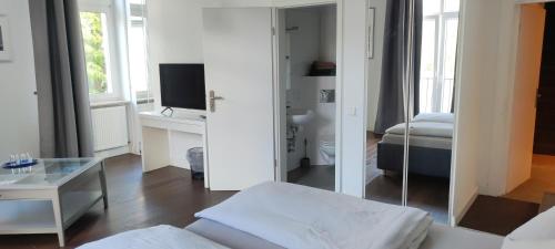 a white room with a bed and a mirror at Hotel Zur Fähre in Boppard
