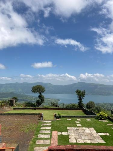 a view of a garden with a view of a lake at Dream House in Satara