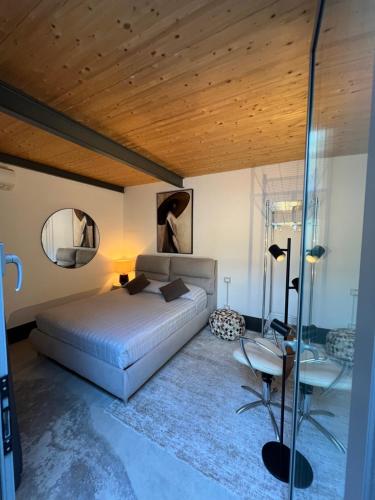 a bedroom with a bed and a table and a mirror at LoftDesign in Verona
