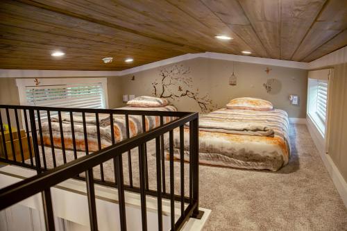 two twin beds in a room with a staircase at Tiny Home - Grill, Near East Fork in Mentone