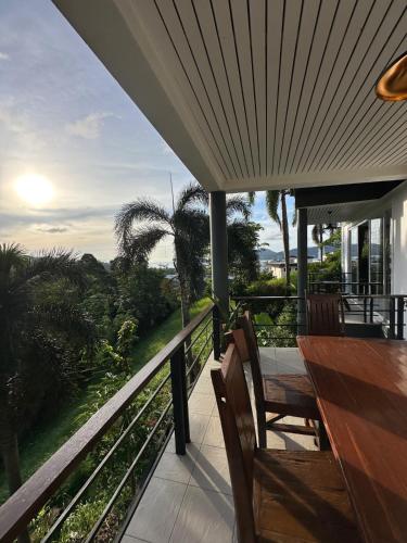 a porch with a table and chairs on a balcony at Quiet Seaview House 1 Bedroom Patong in Patong Beach