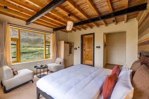 a bedroom with a large bed and a couch at House on the Clouds, Spiti in Domli