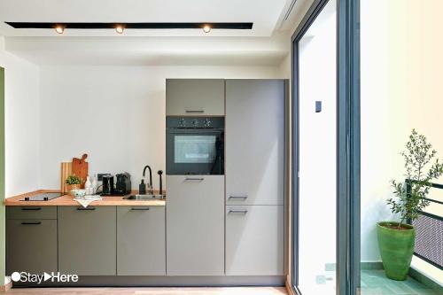 a kitchen with a refrigerator and a counter at Stayhere Casablanca - Maarif - Elite Residence in Casablanca