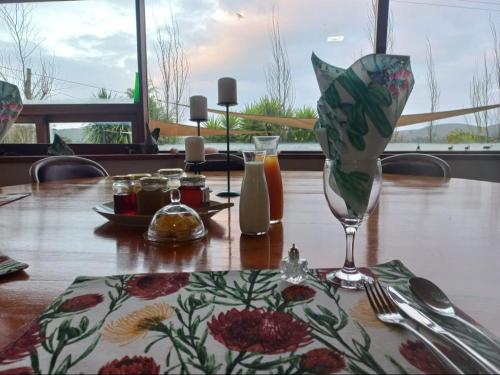 a table with a table cloth with a wine glass at Merwenstein B&B Homestay in Bonnievale
