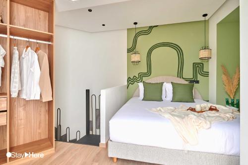 a bedroom with a white bed and a green wall at Stayhere Casablanca - Maarif - Elite Residence in Casablanca