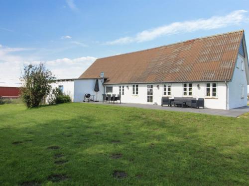 a white building with a brown roof and a yard at Holiday Home Dolfine - 15km from the sea by Interhome in Skærbæk